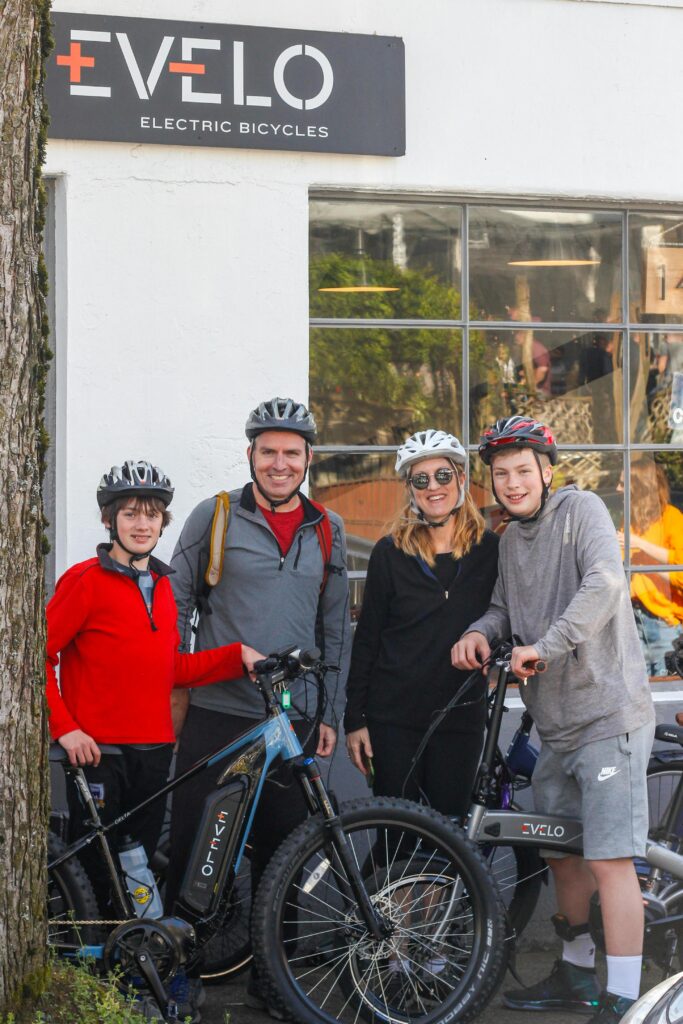 Family with electric bicycles outside an Evelo showroom in Seattle, WA.